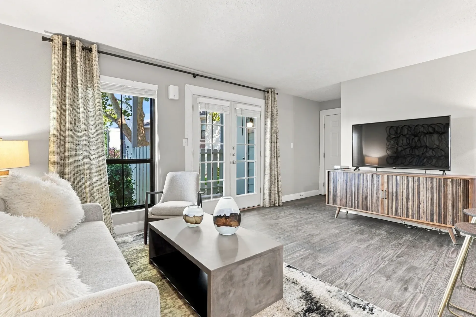 Modern living room with sofa, coffee table, and television.