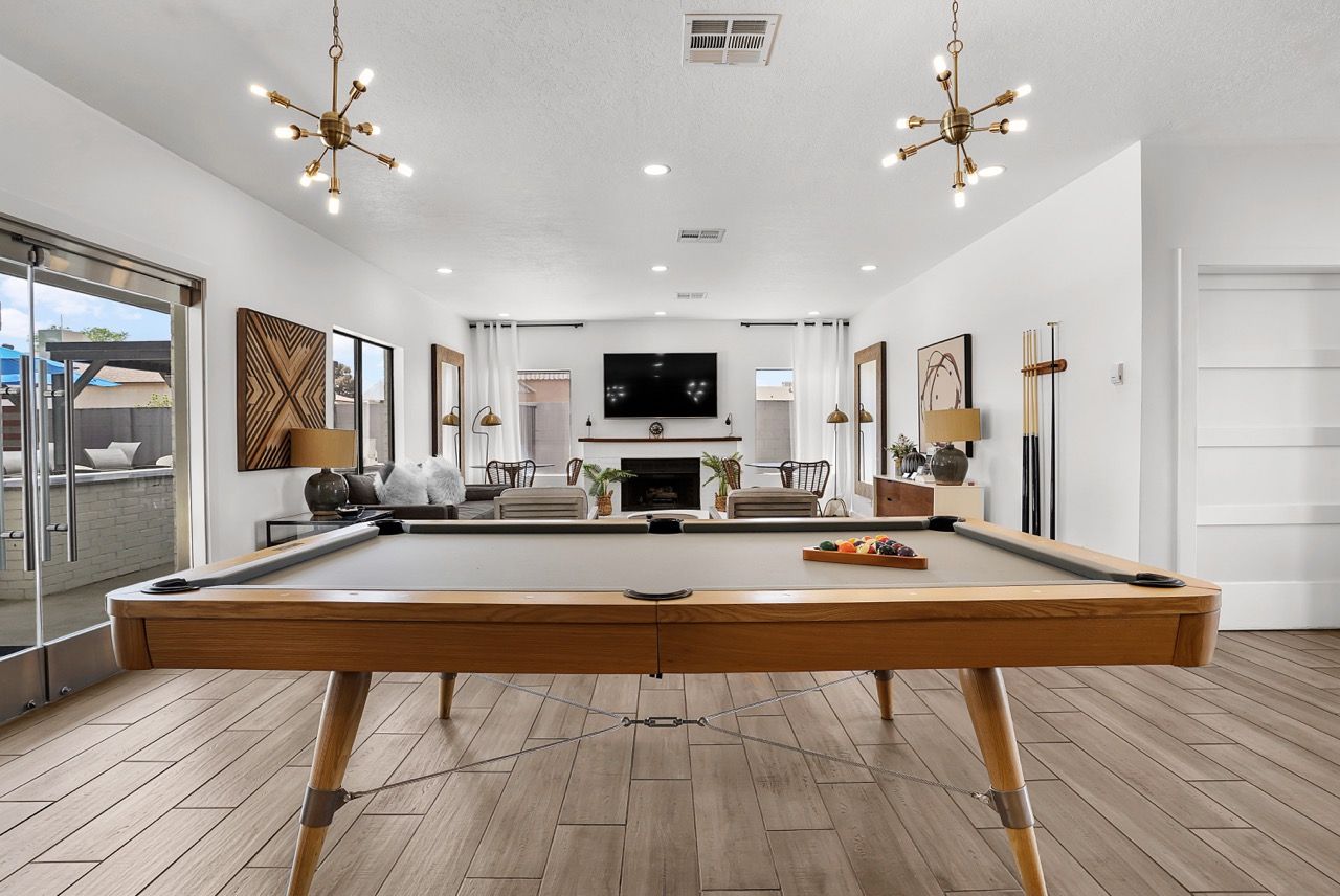 Telegraph Hill community gameroom with a pool table, seating, and a fireplace.