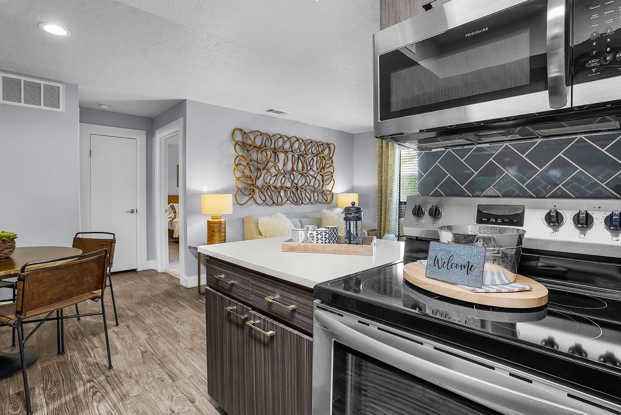 Telegraph Hill kitchen with stainless steel stove and microwave, dark wood cabinets, and a dining table.