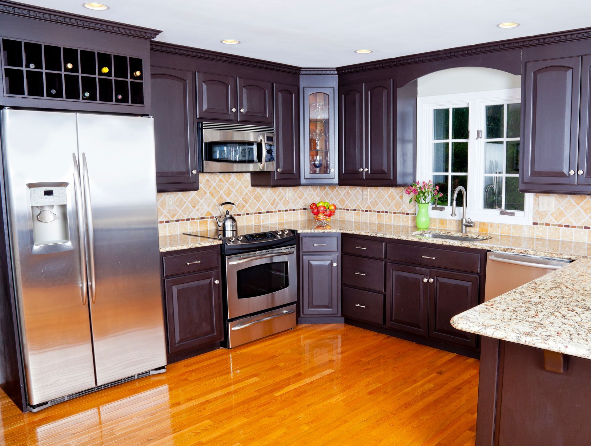 Elegant kitchen with dark wood cabinets by Jax Payless Cabinets in Jacksonville, FL, featuring custom kitchen cabinetry and design.