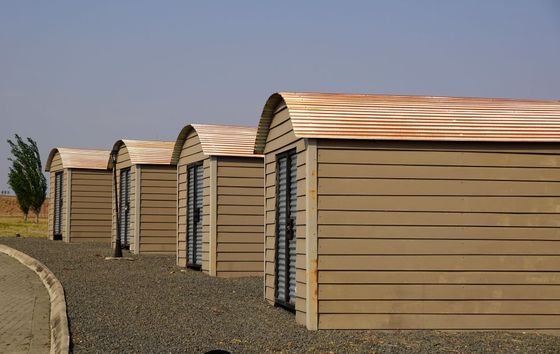 Row of beige storage buildings with on gravel