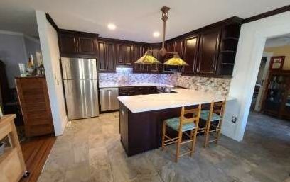 A kitchen with stainless steel appliances and wooden cabinets.