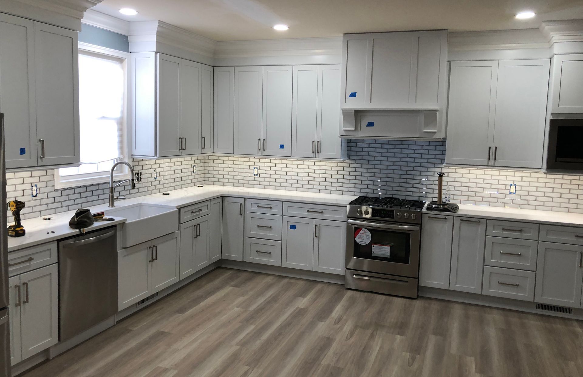 A kitchen with white cabinets and stainless steel appliances.