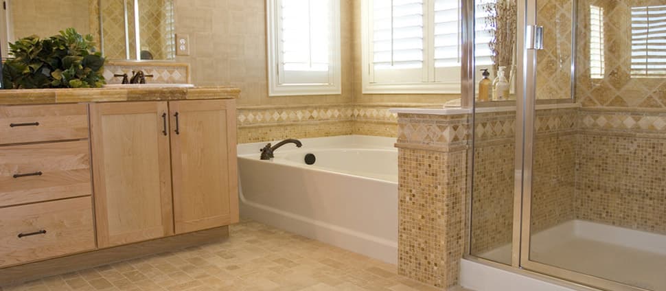 A bathroom with a tub , sink , and shower.