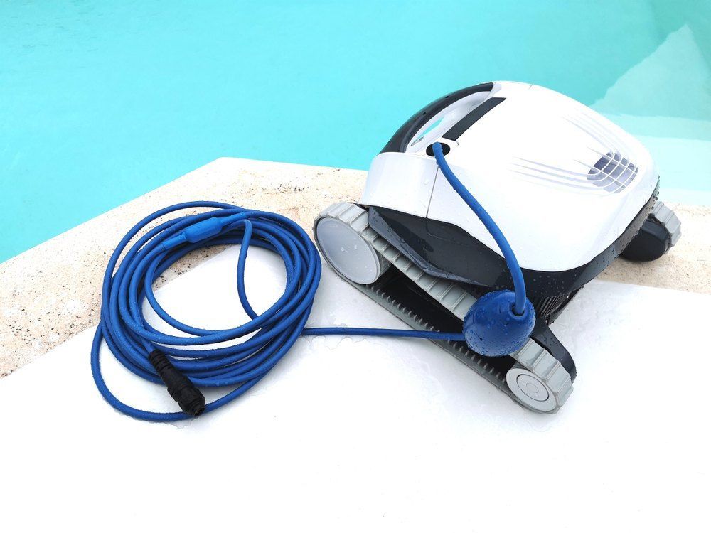 A Robotic Pool Cleaner With a Blue Cord Attached to It — Tweed Coast Pool Care in South Murwillumbah, NSW