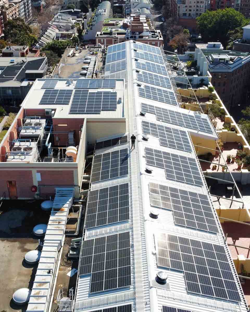 An Aerial View Of A Building With Solar Panels On The Roof — CJ Electrical & Solar In Cessnock, NSW