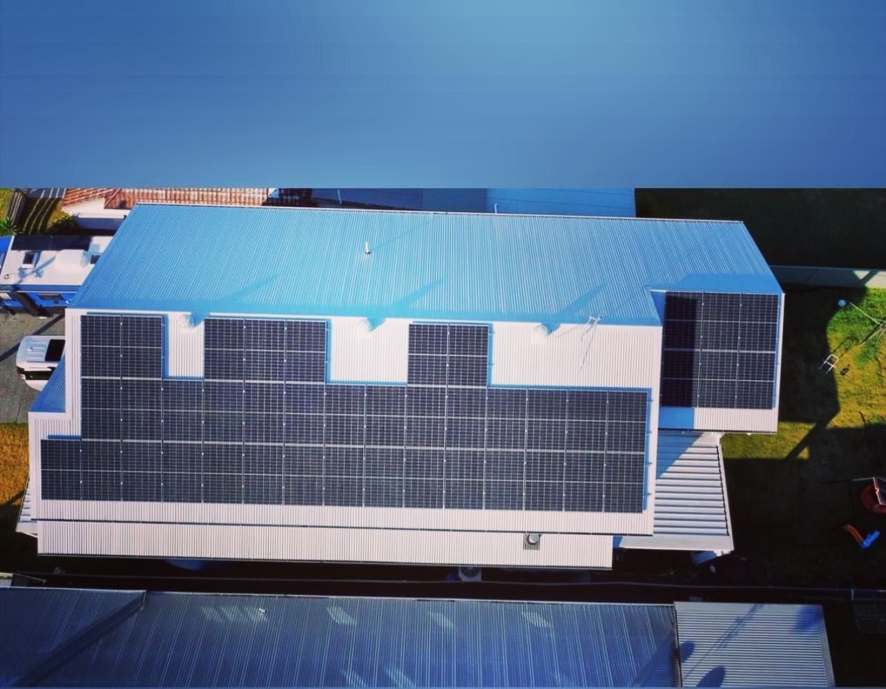 An Aerial View Of A Building With Solar Panels On The Roof — CJ Electrical & Solar In Belmont, NSW