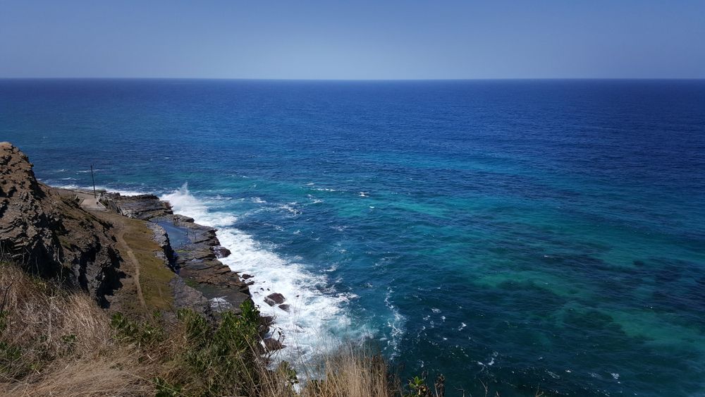 A View Of The Ocean From A Cliff On A Sunny Day — CJ Electrical & Solar In Morisset, NSW