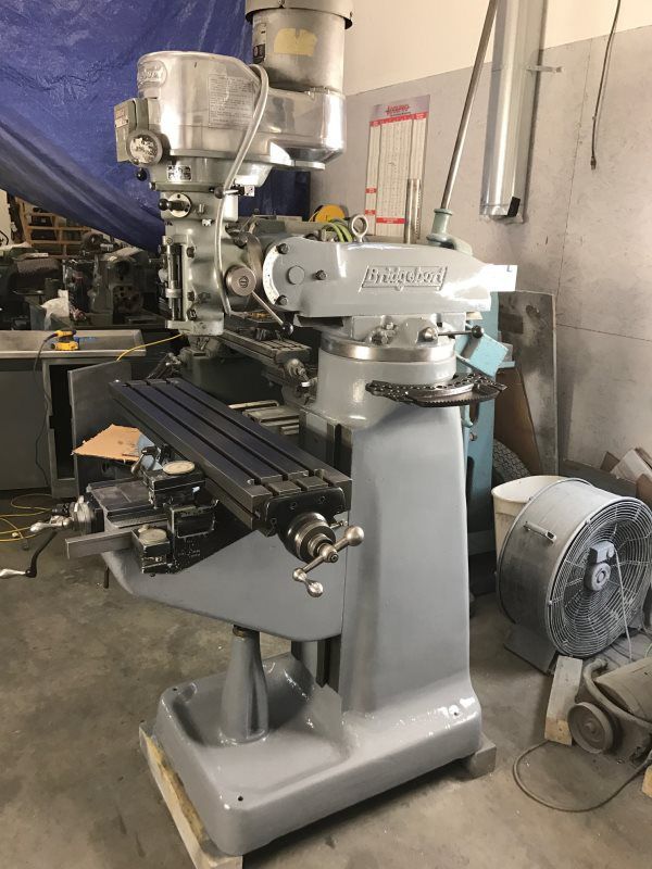 A machine is sitting in a room next to a fan.