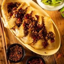 A close up of a plate of food on a wooden table.