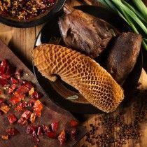 A close up of a plate of food on a wooden table.