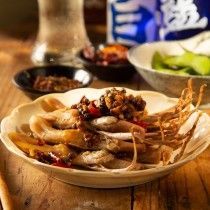 A close up of a plate of food on a wooden table.