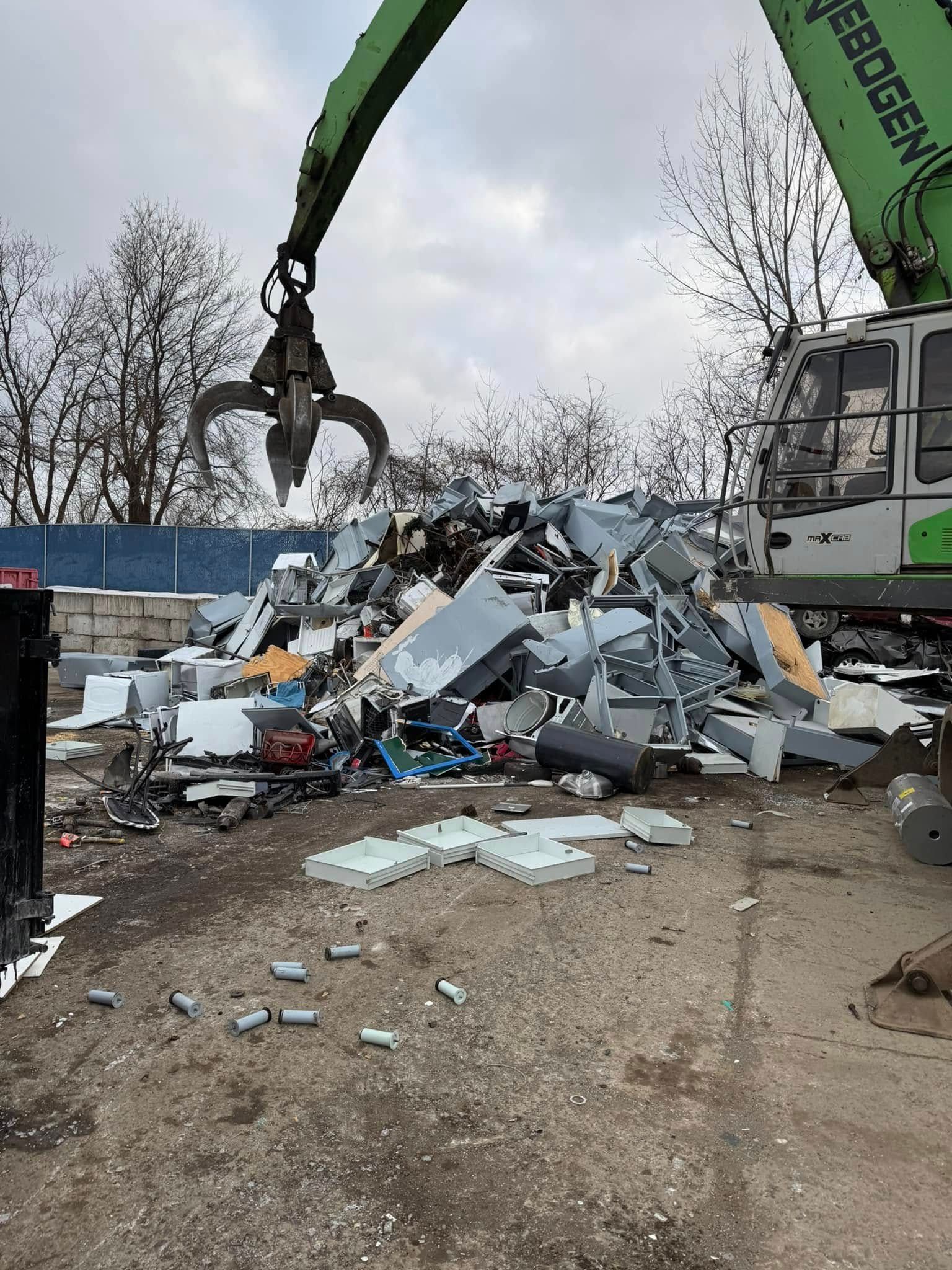 A trailer overflowing with construction debris, including wood and other materials, parked outdoors.