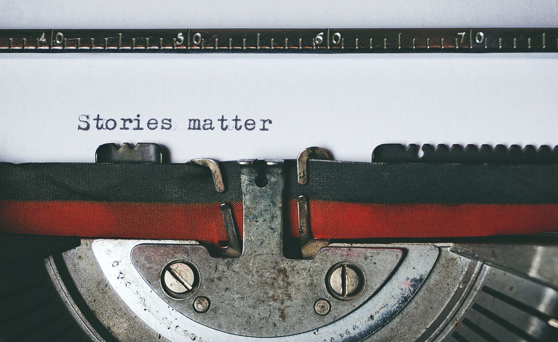 Photograph of a typewriter carriage, the words 'Stories matter' have been typed onto the page.