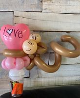 A pink heart with the word love written on it