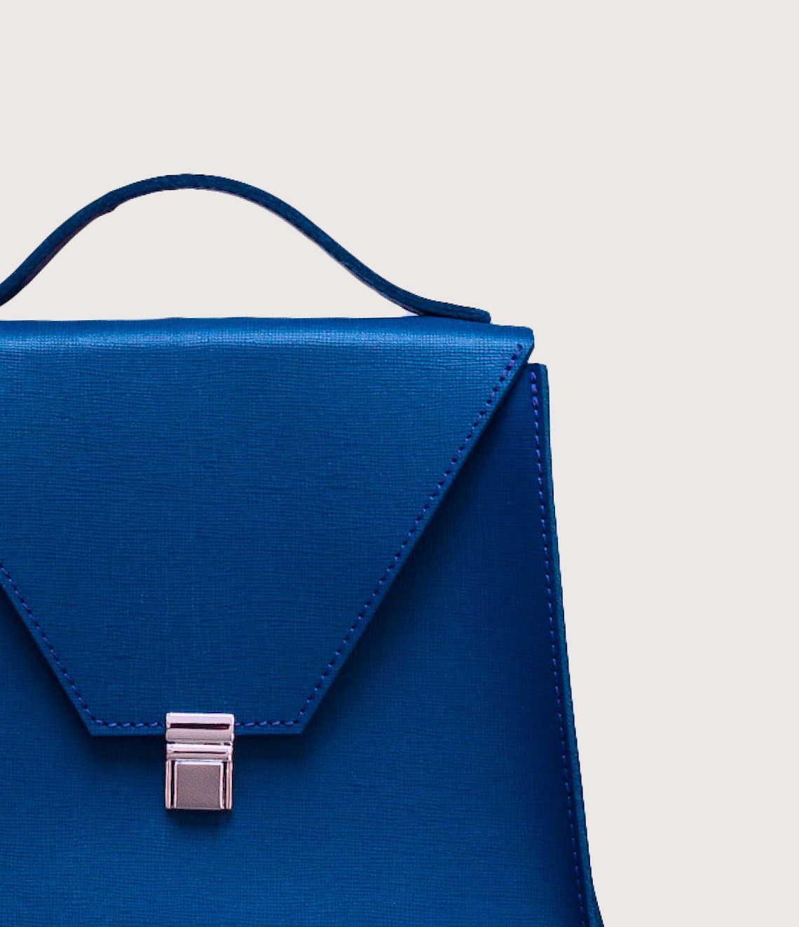 A blue briefcase with a silver clasp and handle
