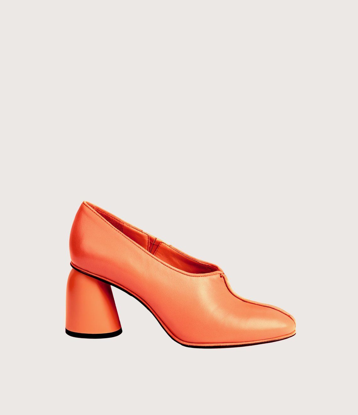 A pair of orange shoes with a block heel on a white background.