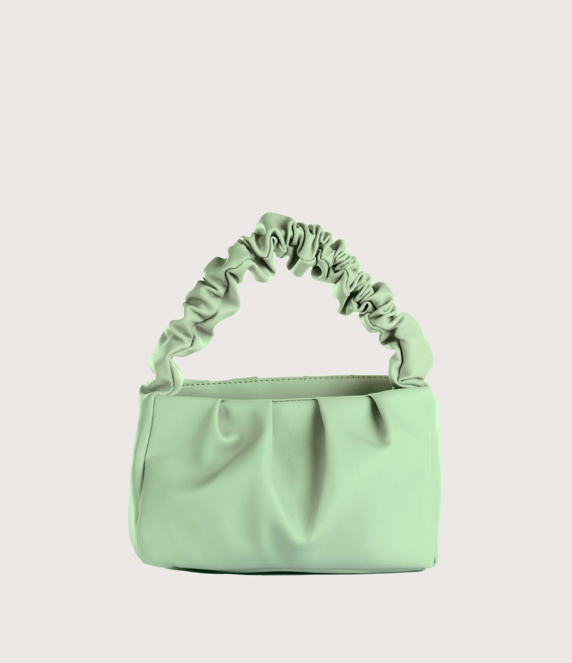 A green purse with a ruffled handle on a white background.