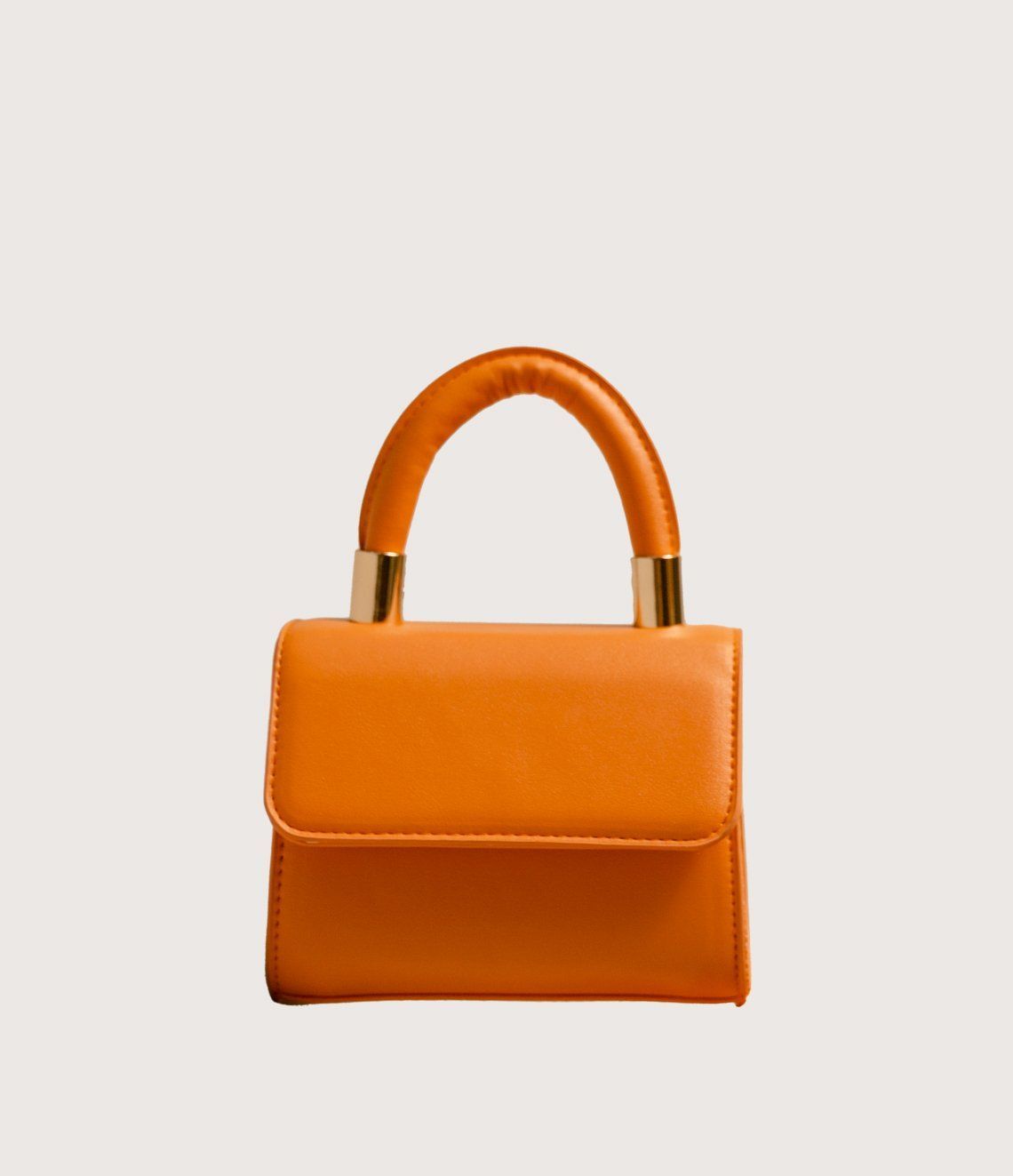 A small orange purse with a gold handle on a white background.
