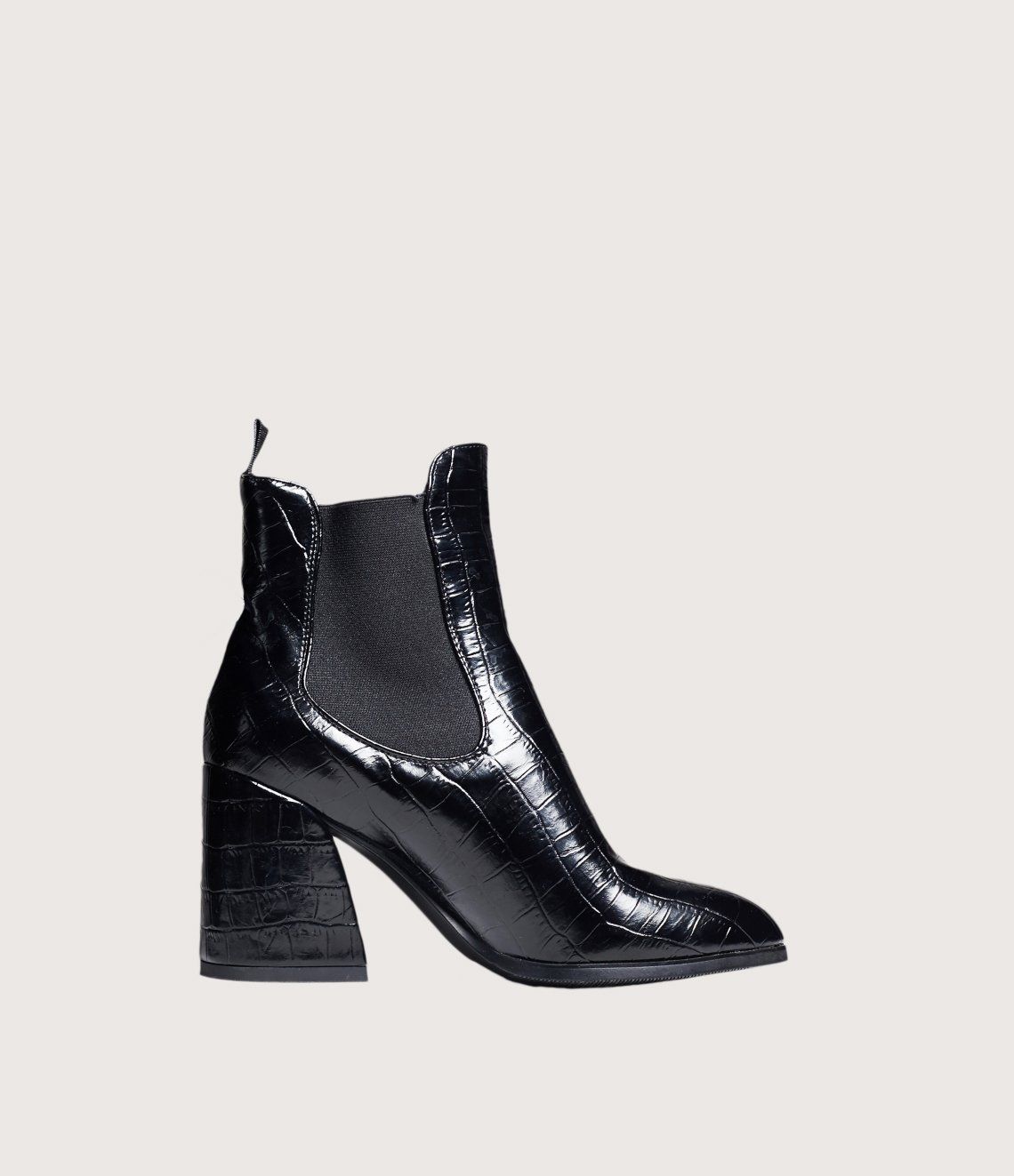 A pair of black ankle boots with a high heel on a white background.