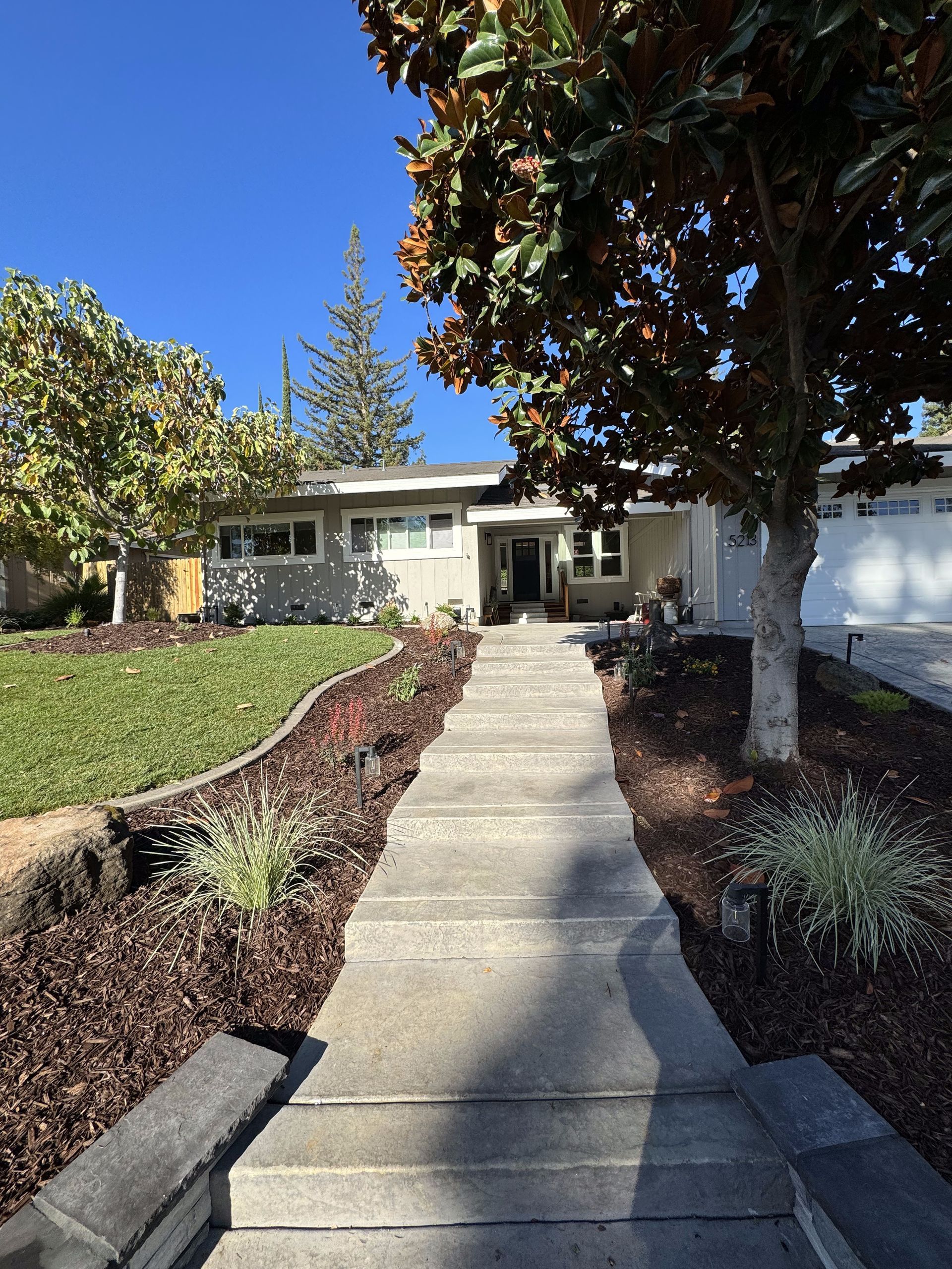 A house with a concrete walkway leading to it
