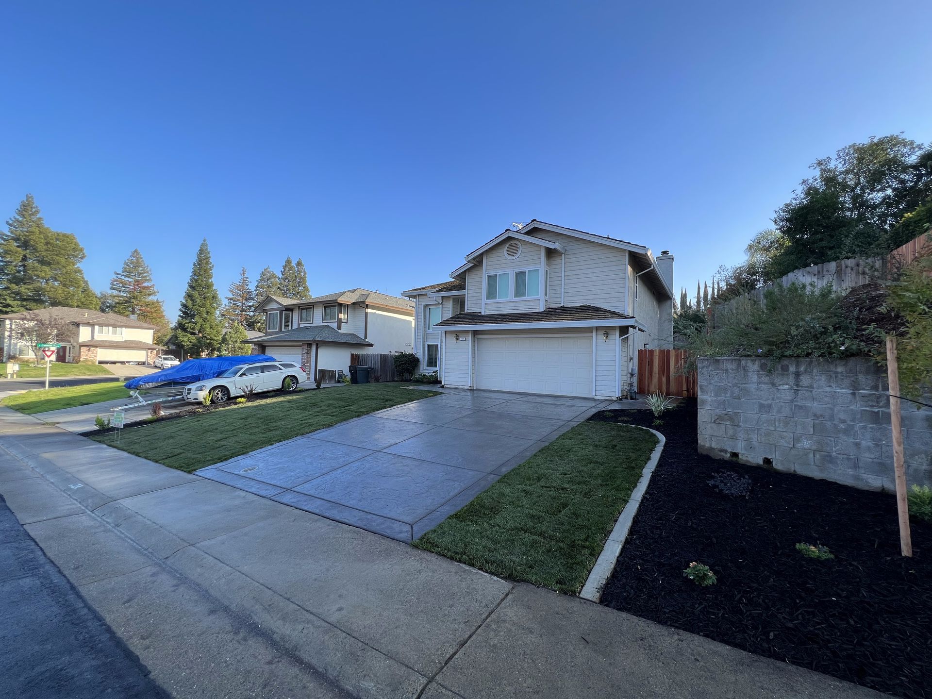 A house with a car parked in front of it in a residential neighborhood.
