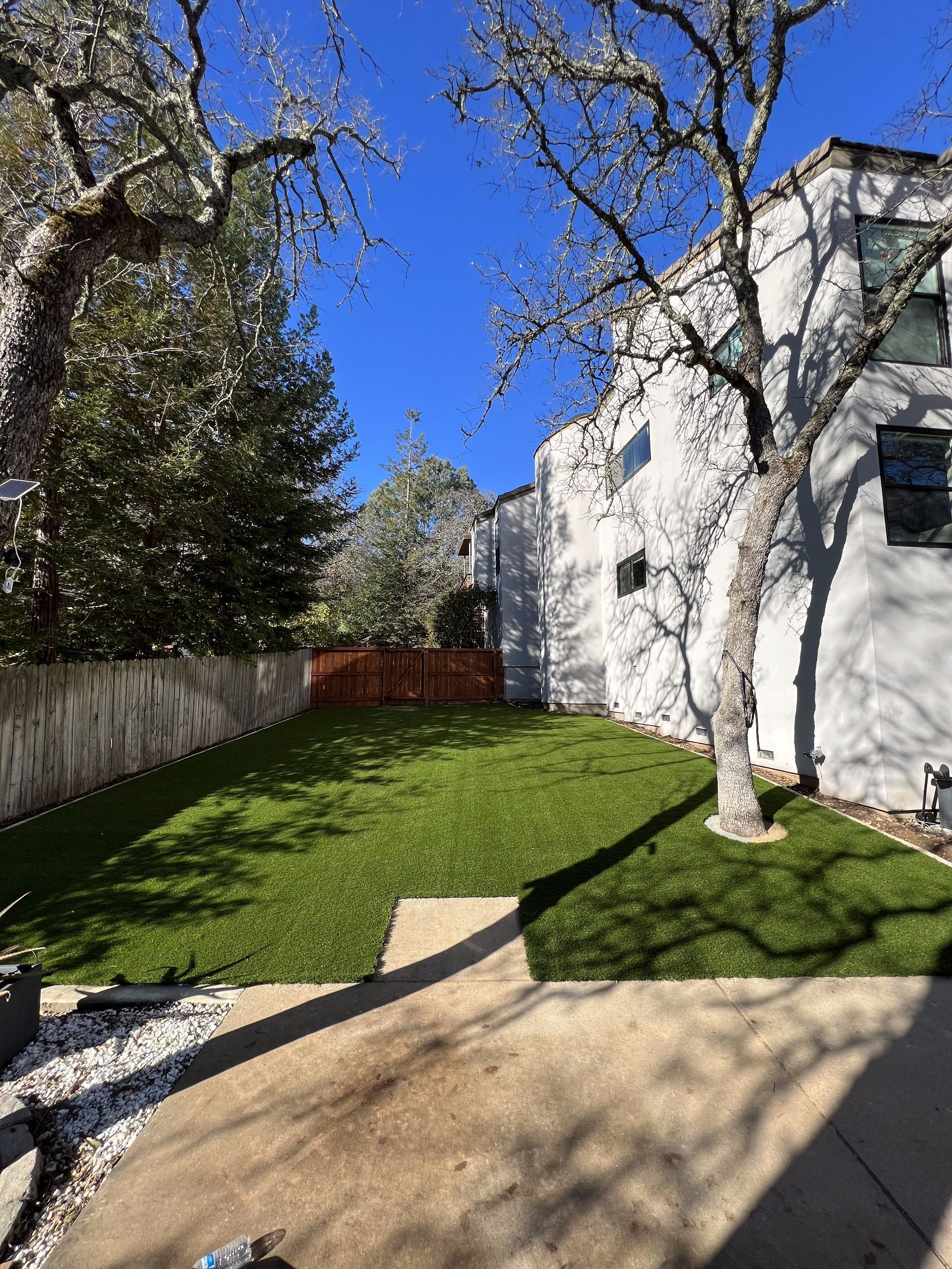 A large white house with a lush green lawn in front of it.