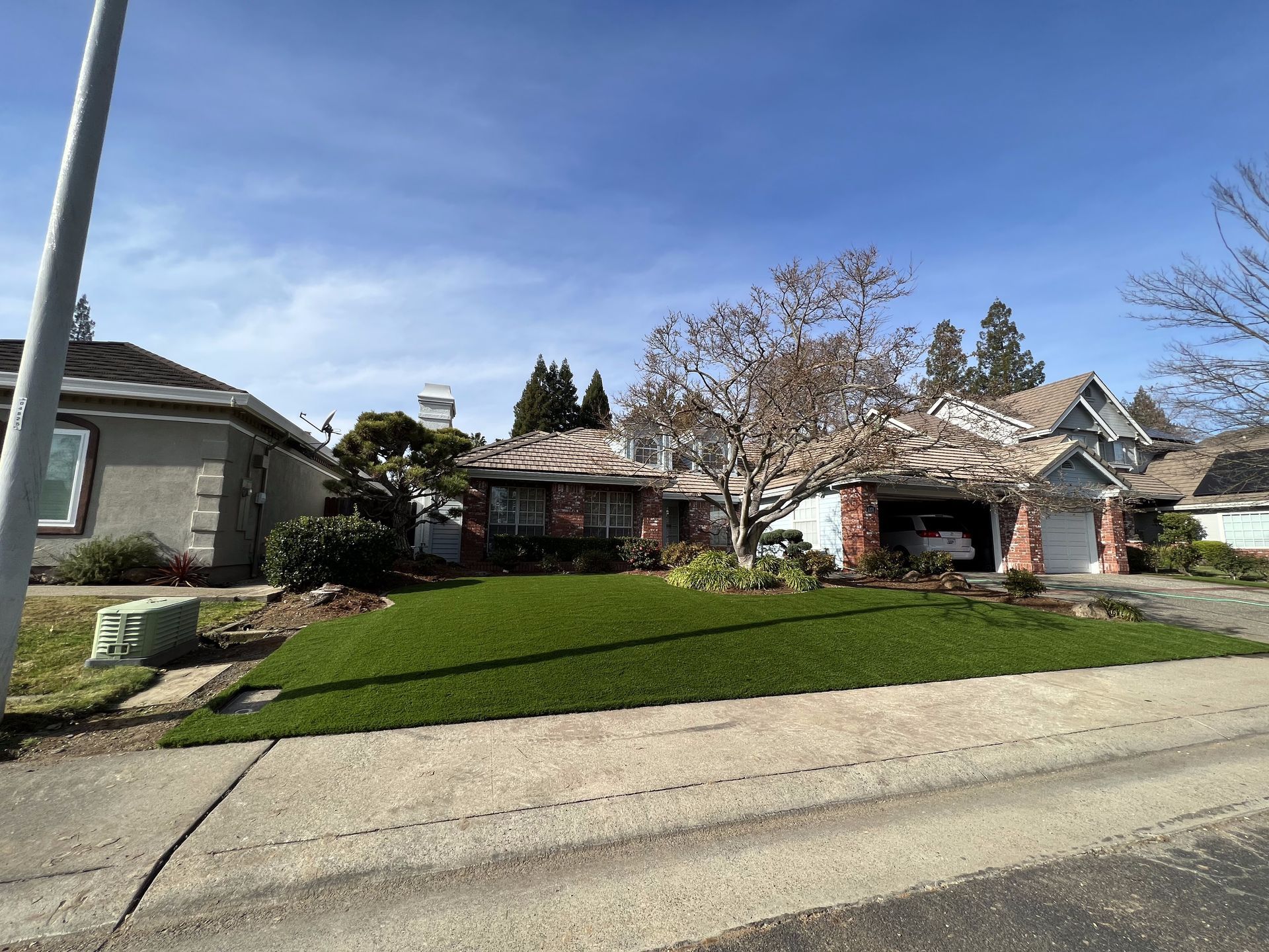 A house with a lush green lawn in front of it