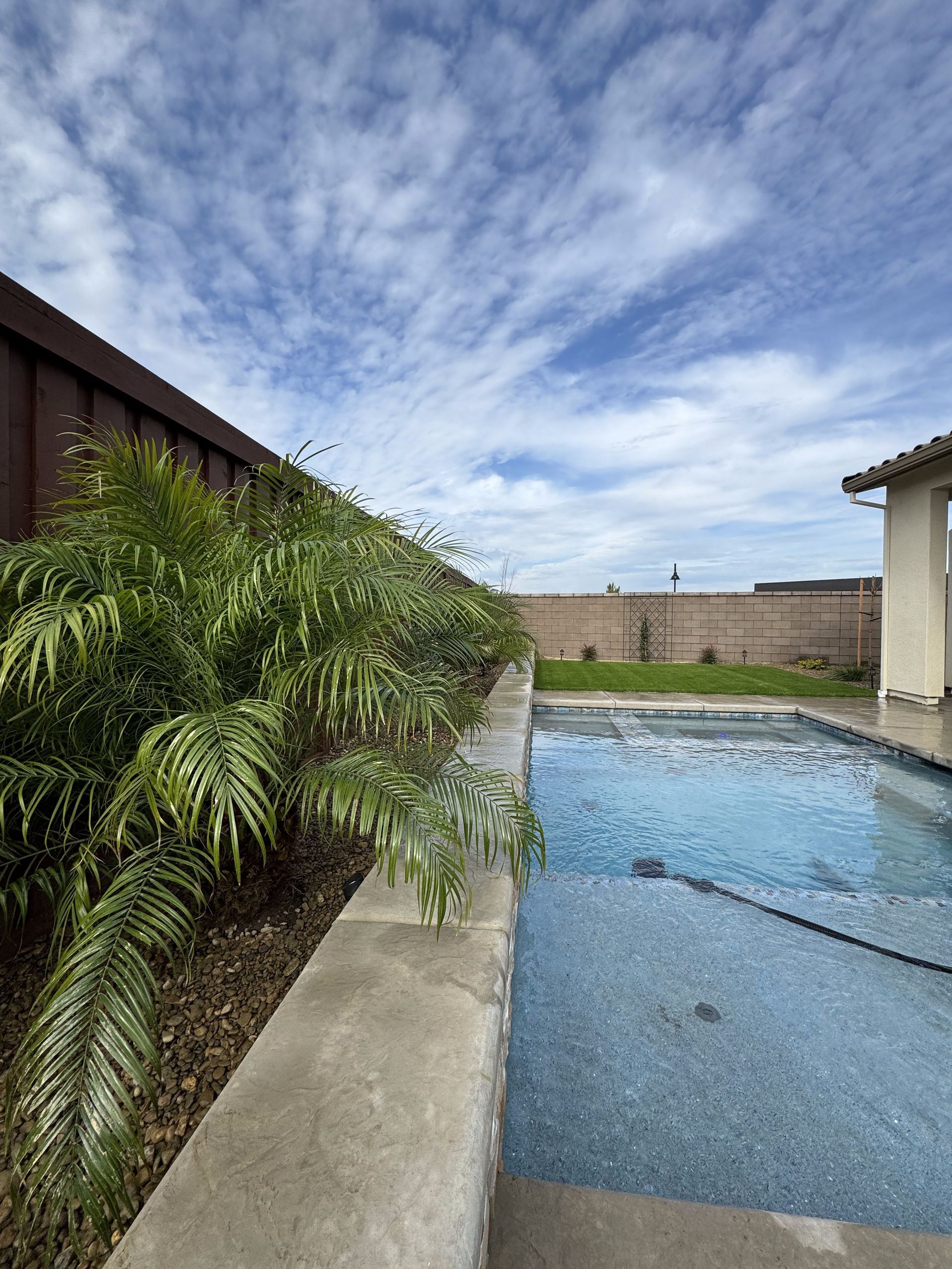 A large swimming pool in the backyard of a house