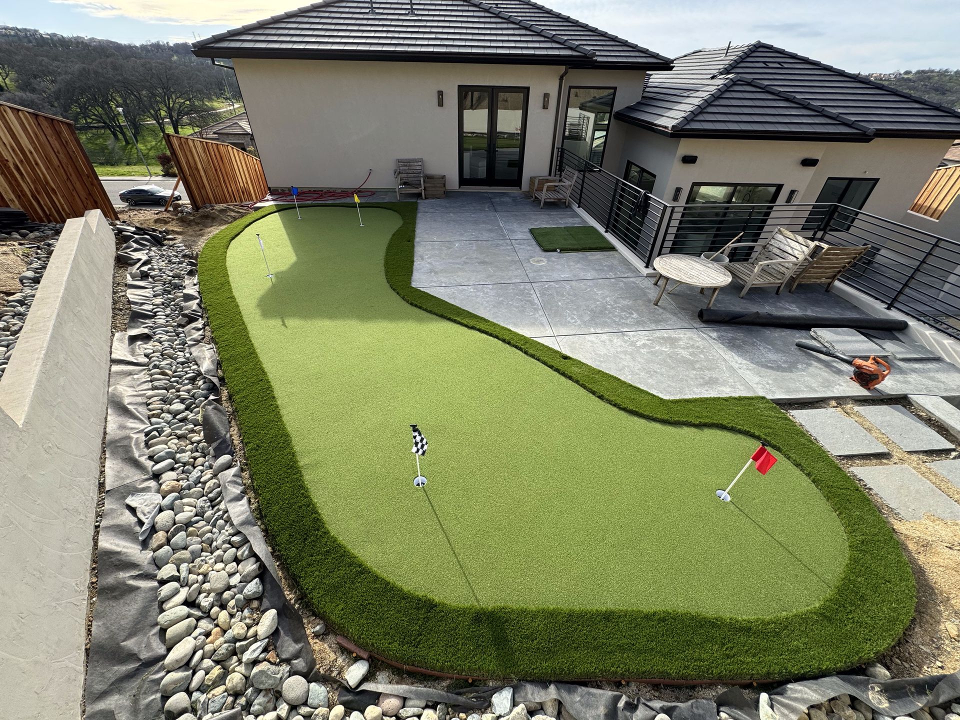 A house with a putting green in front of it