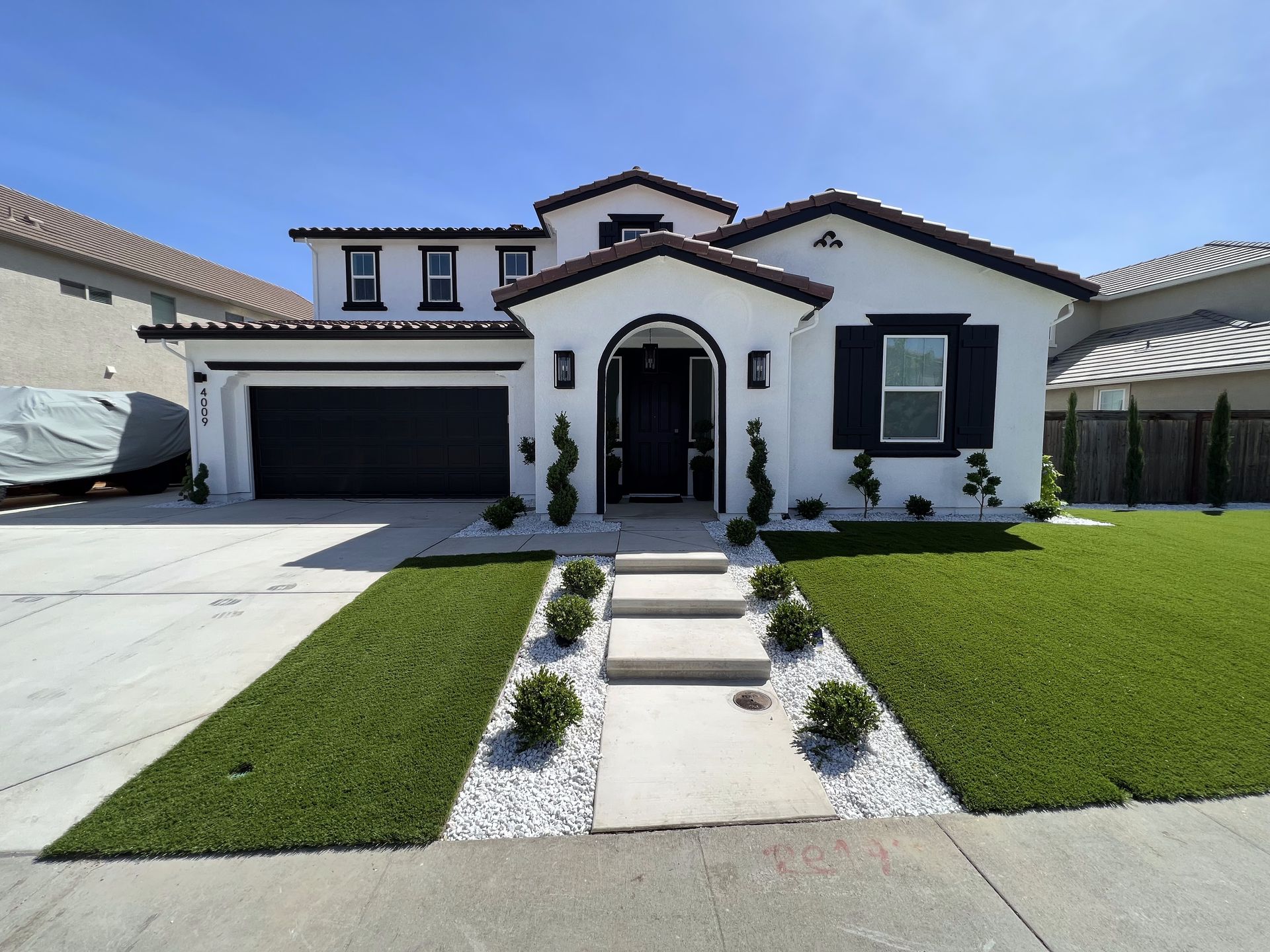A large white house with a black garage door