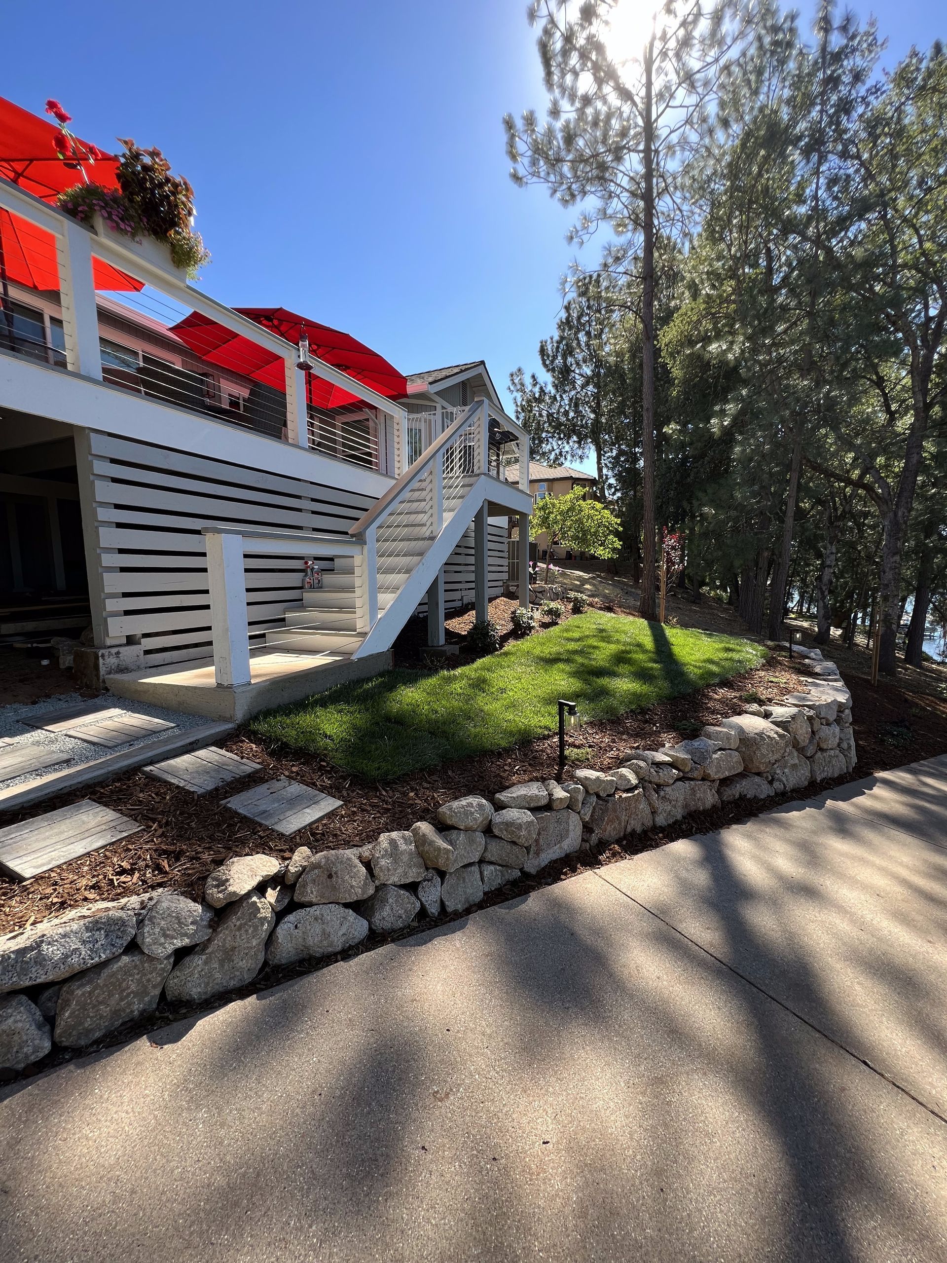A house with a large deck and stairs leading up to it