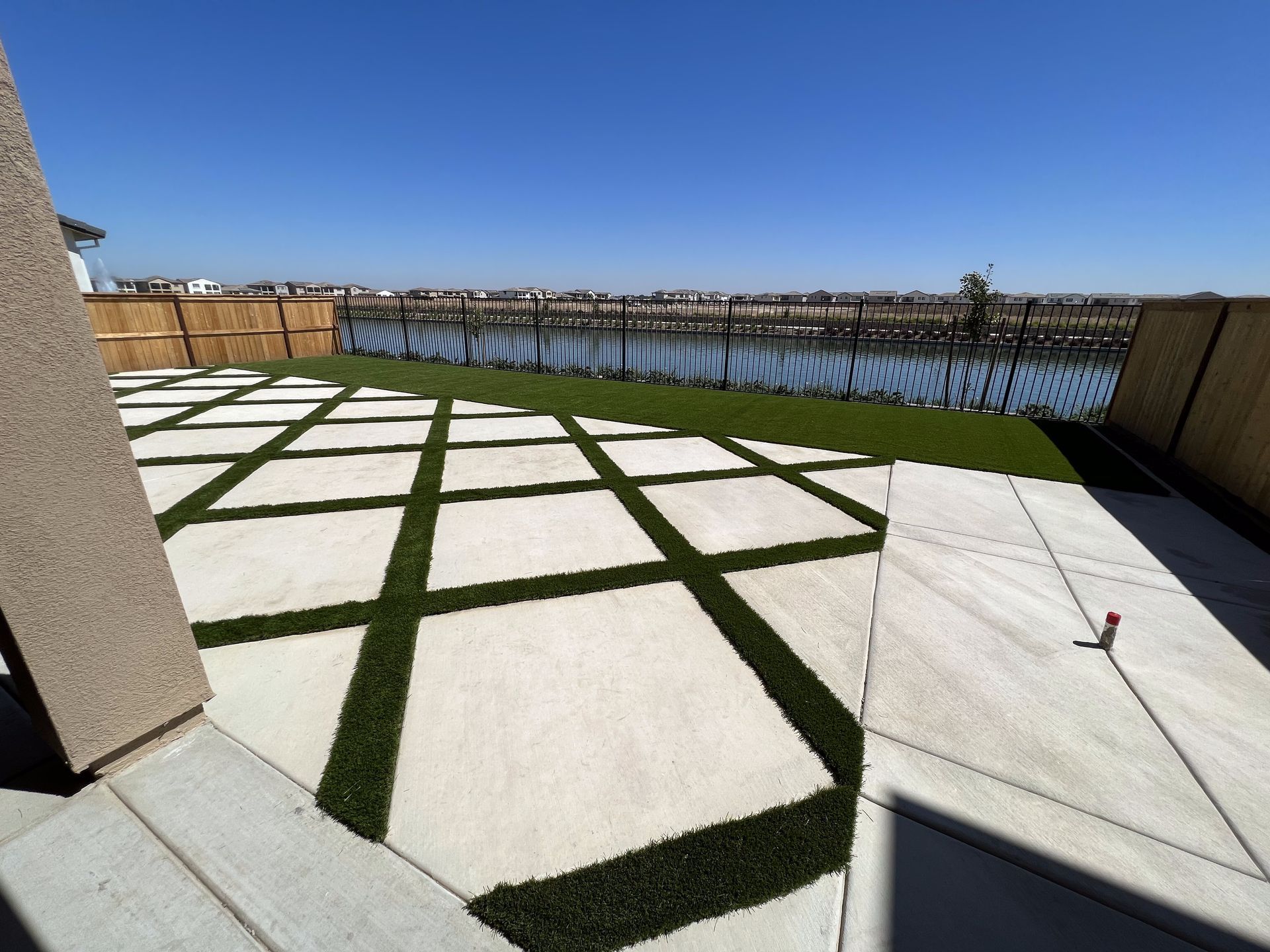 A patio with a view of a body of water