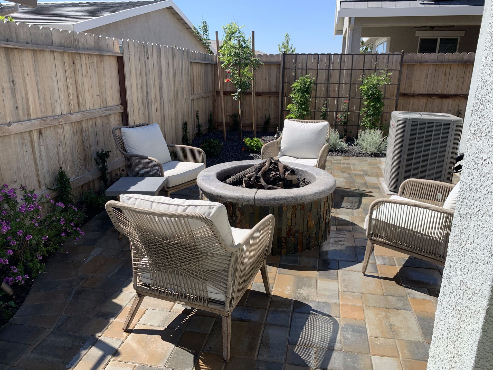 There is a fire pit in the middle of the patio.