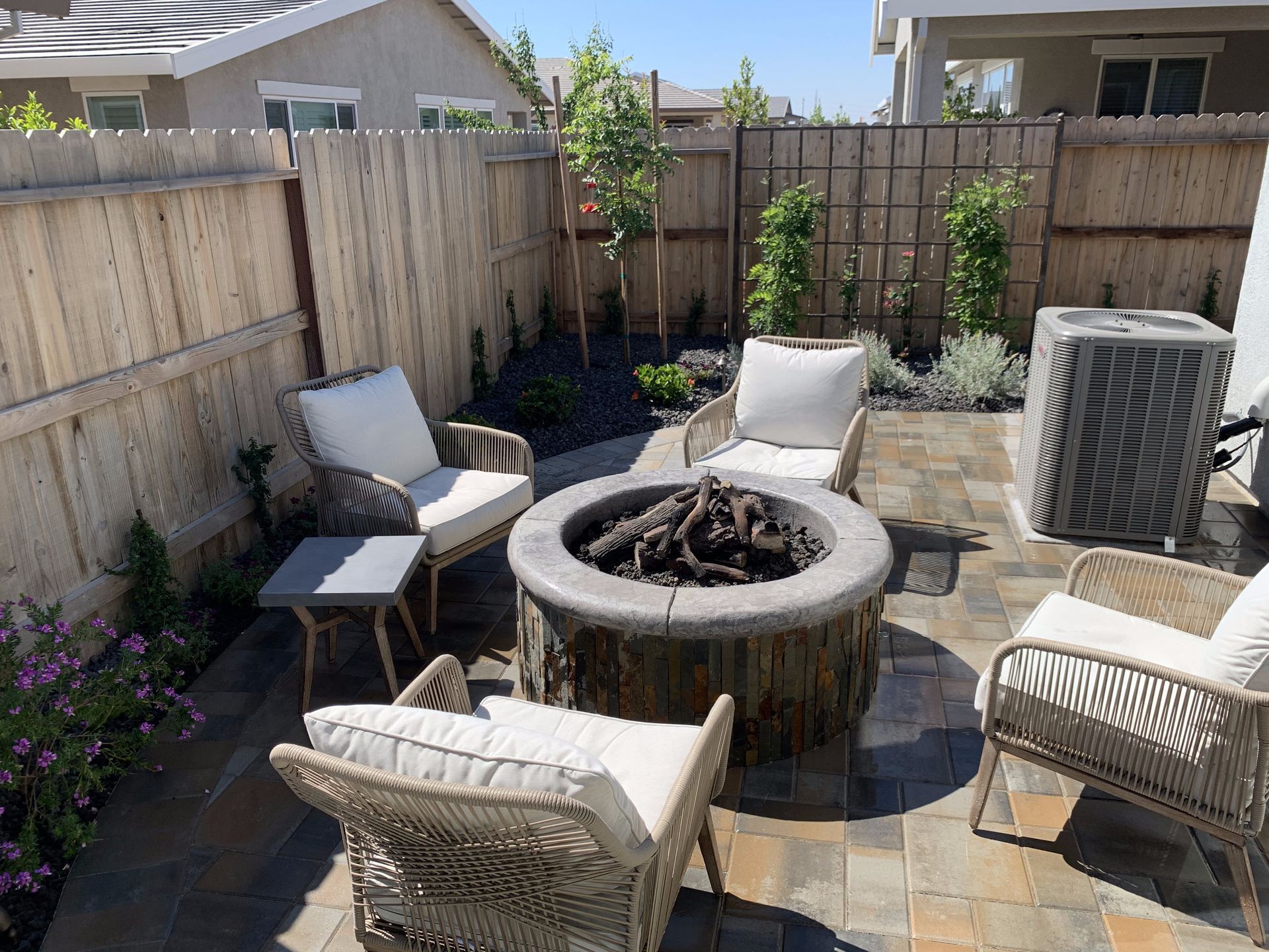There is a fire pit in the middle of the patio.
