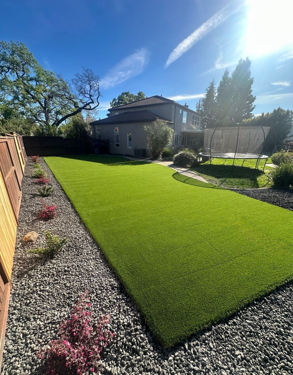A house with a putting green in front of it