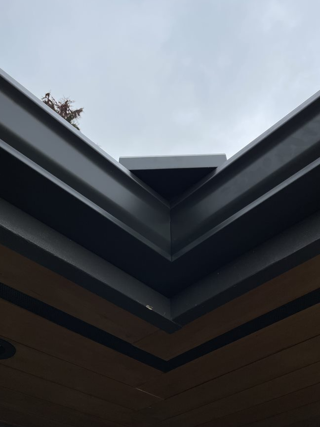 Looking up at a roof with a tree in the background
