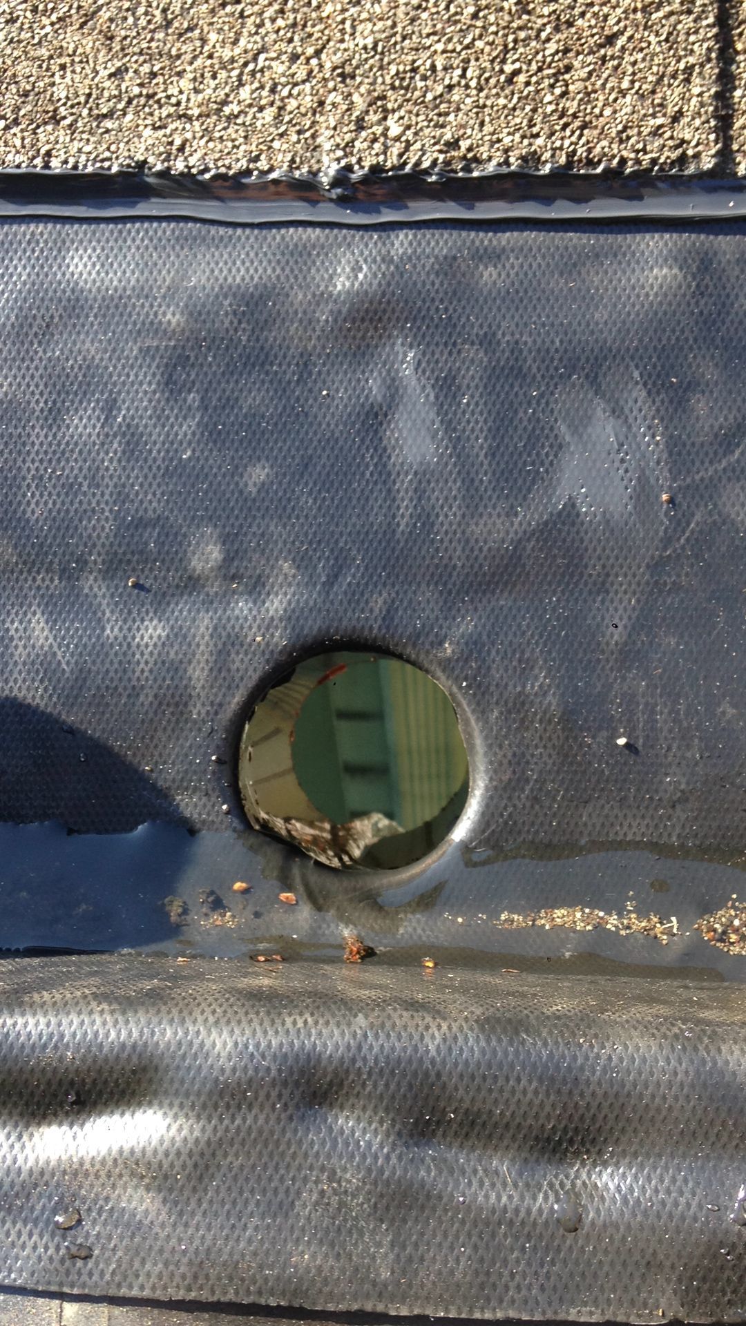 A close up of a hole in a roof with a hole in it.