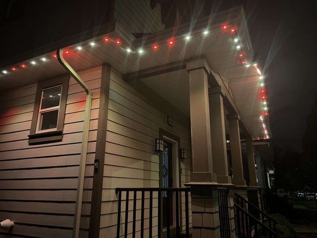 A house with christmas lights on the porch at night