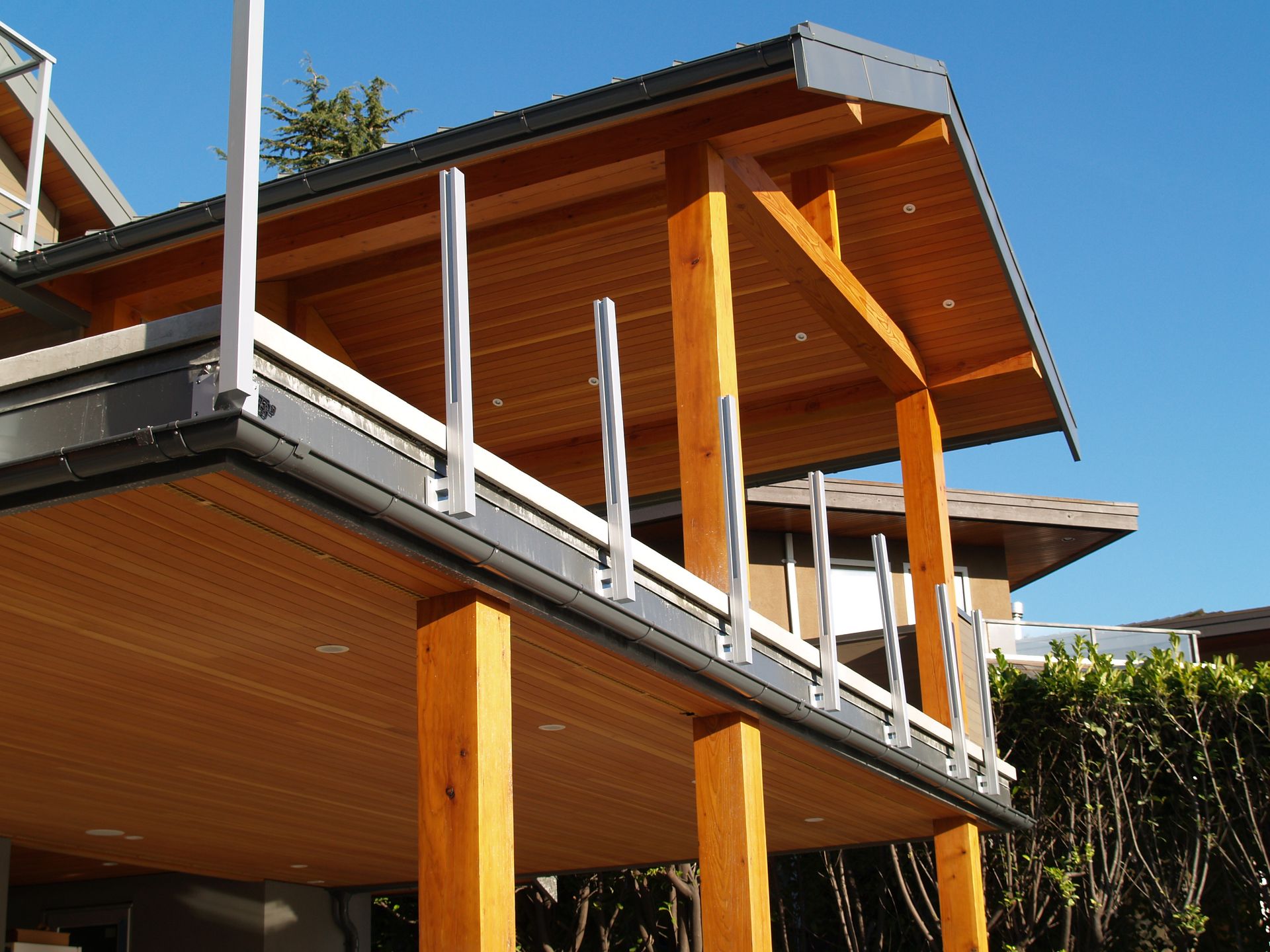 A house with a balcony and a roof made of wood