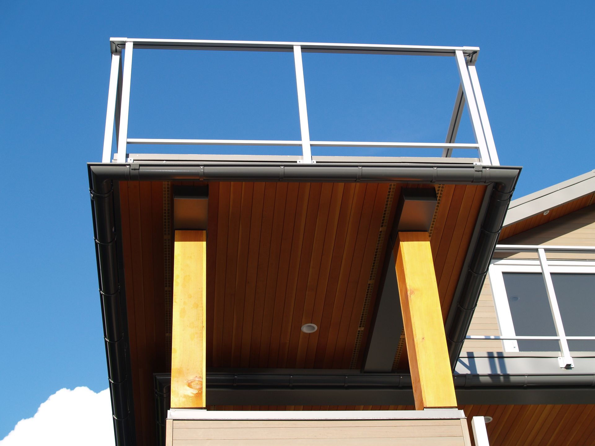 A balcony on the side of a house with a blue sky in the background