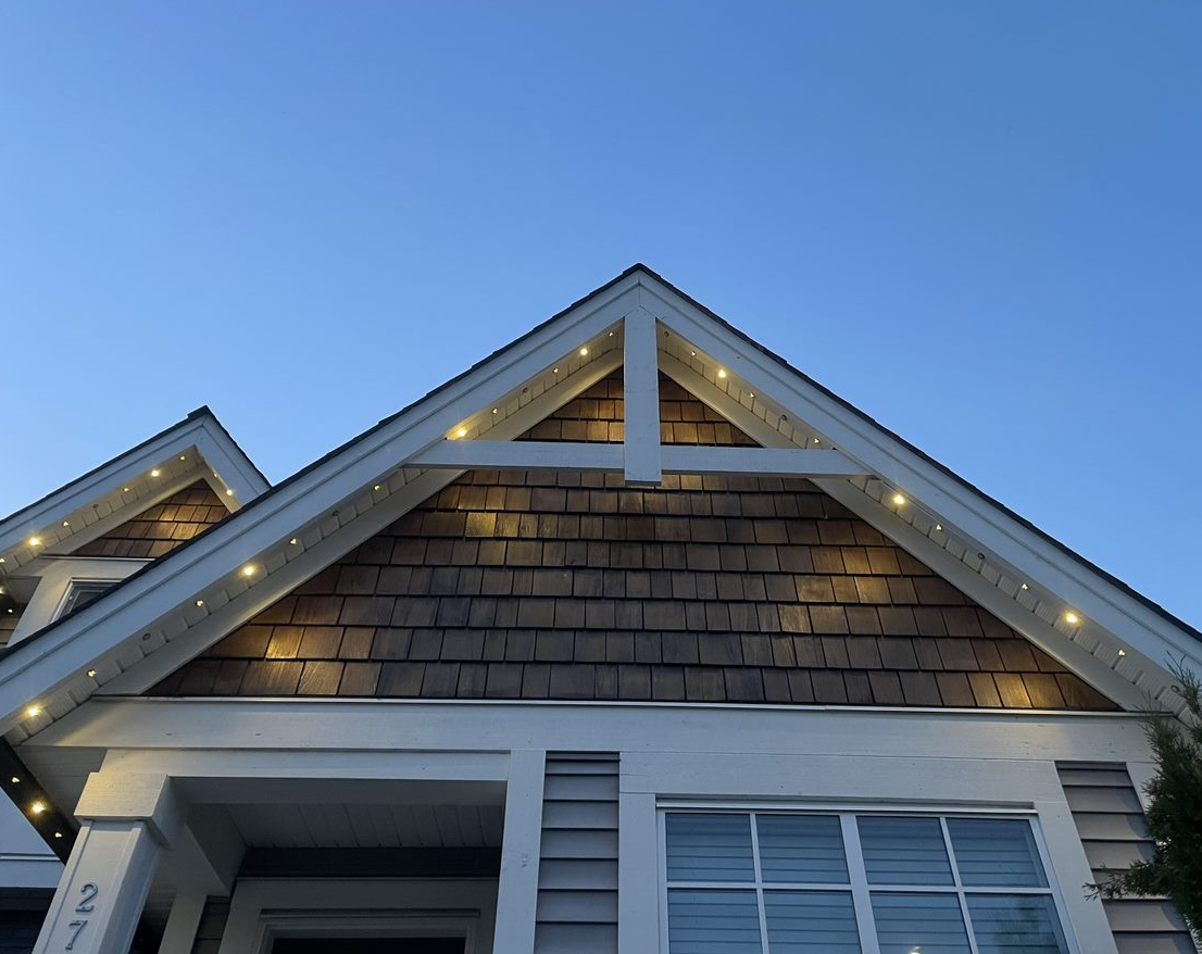 Looking up at the roof of a house with a blue sky in the background