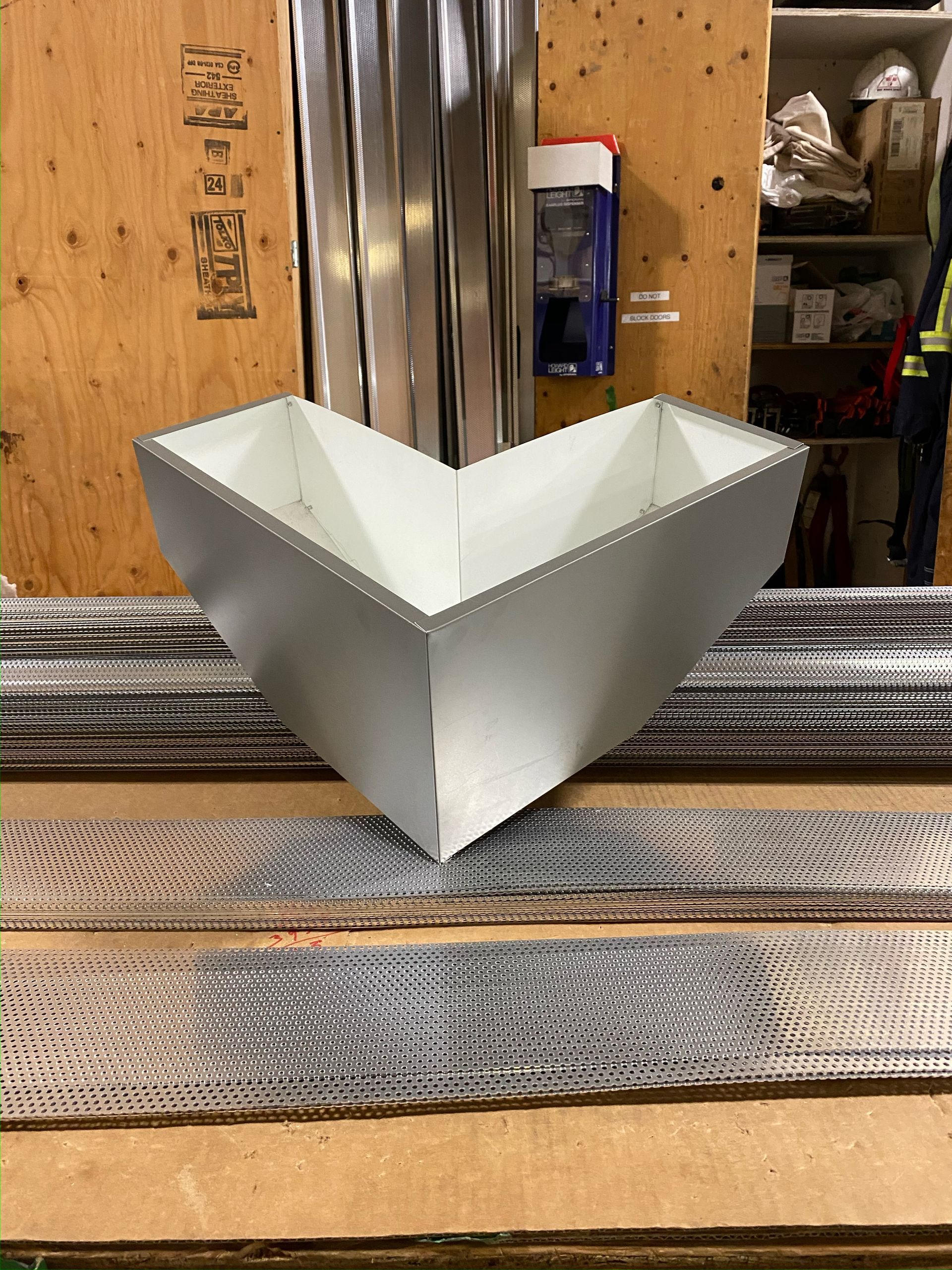 A piece of metal is sitting on top of a wooden table.