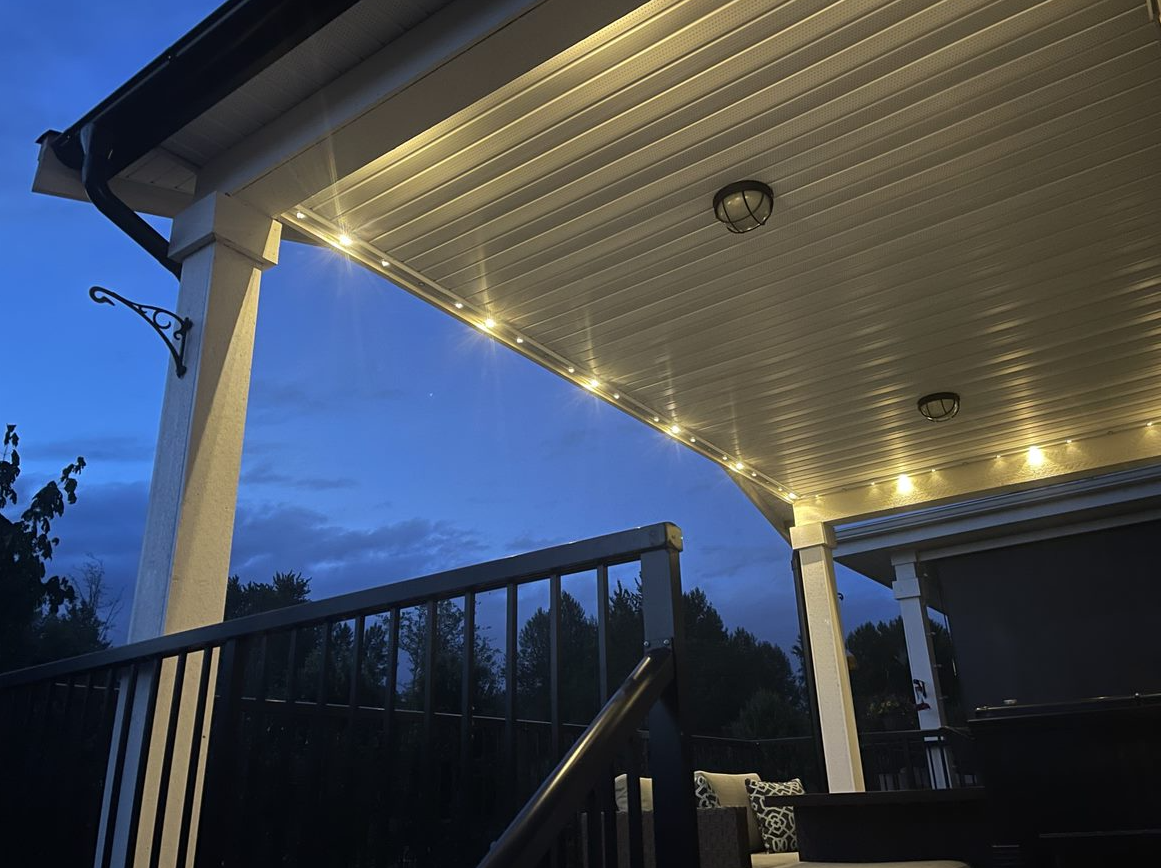 A porch with lights on it at night.