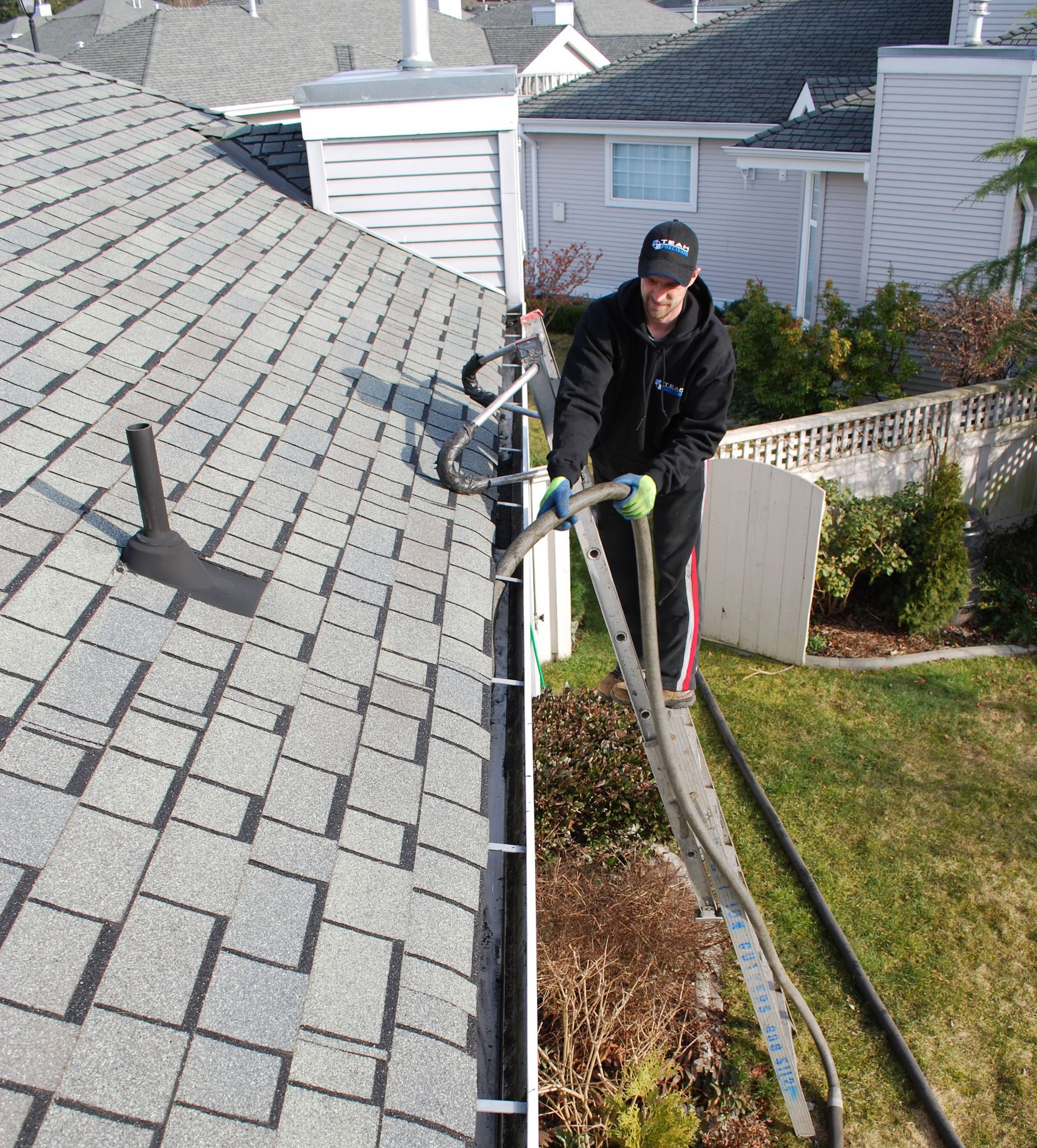 man cleaning gutter