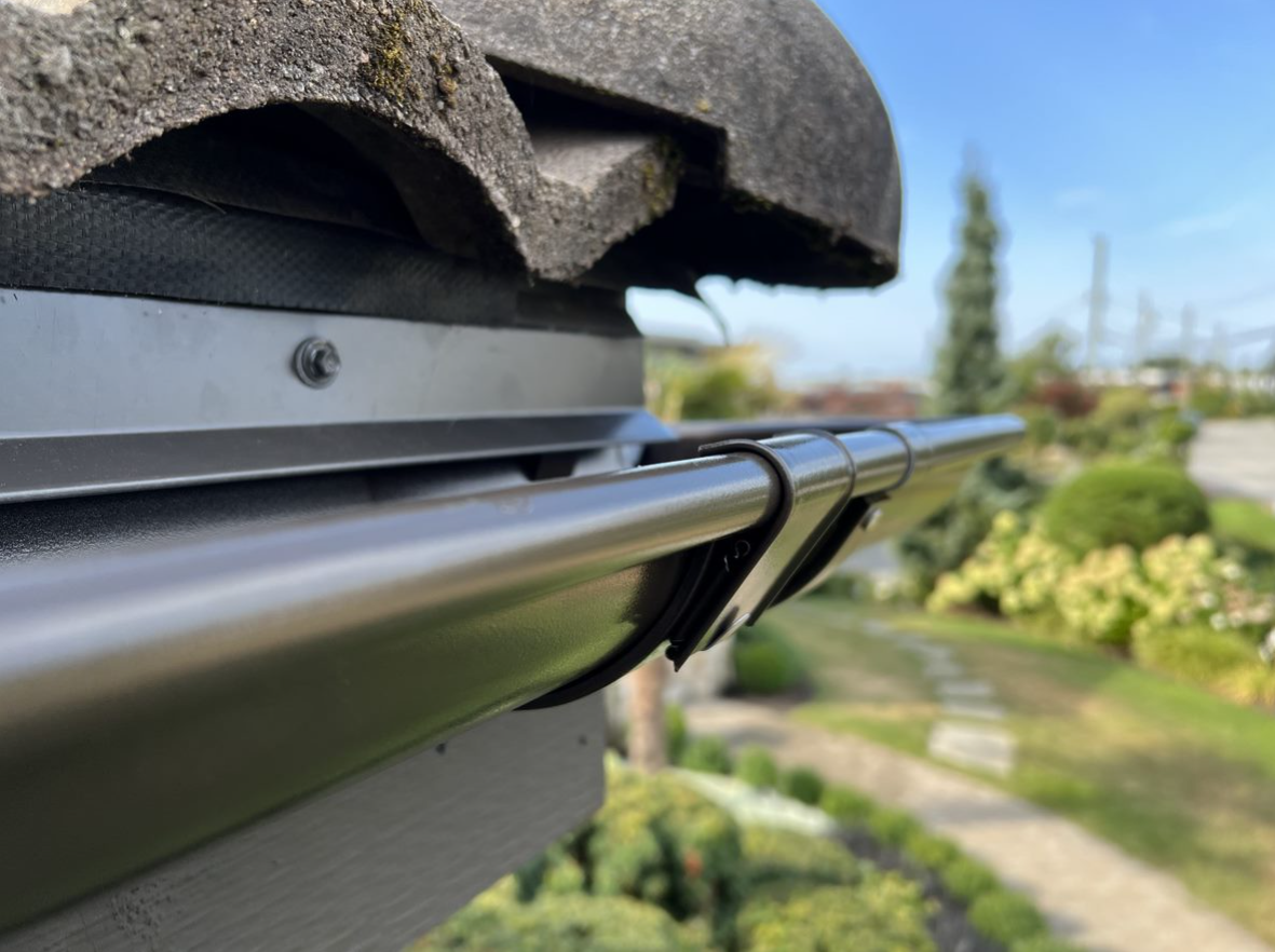 A close up of a gutter attached to a roof.