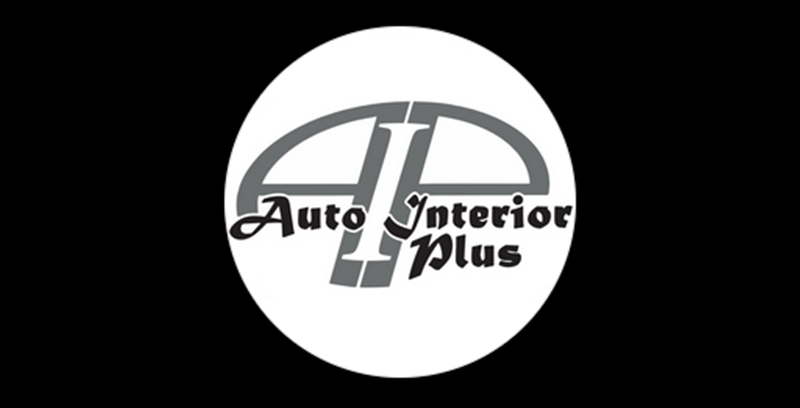 Auto Interior Plus logo in black and gray on a white circle, centered on a black background