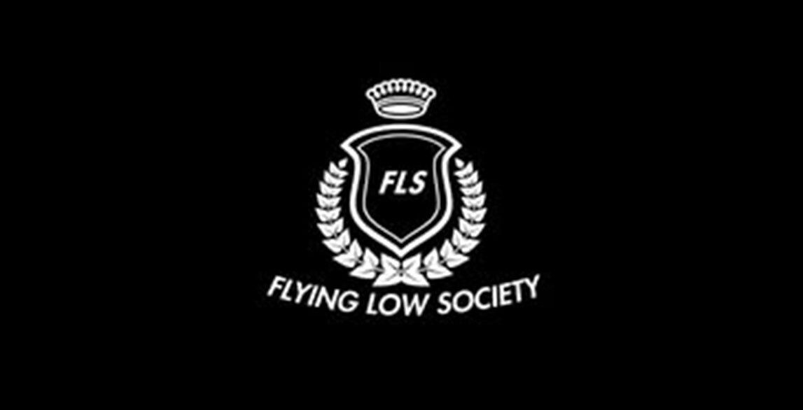 A shield with the words “Flying Low Society” below it in white on a black background