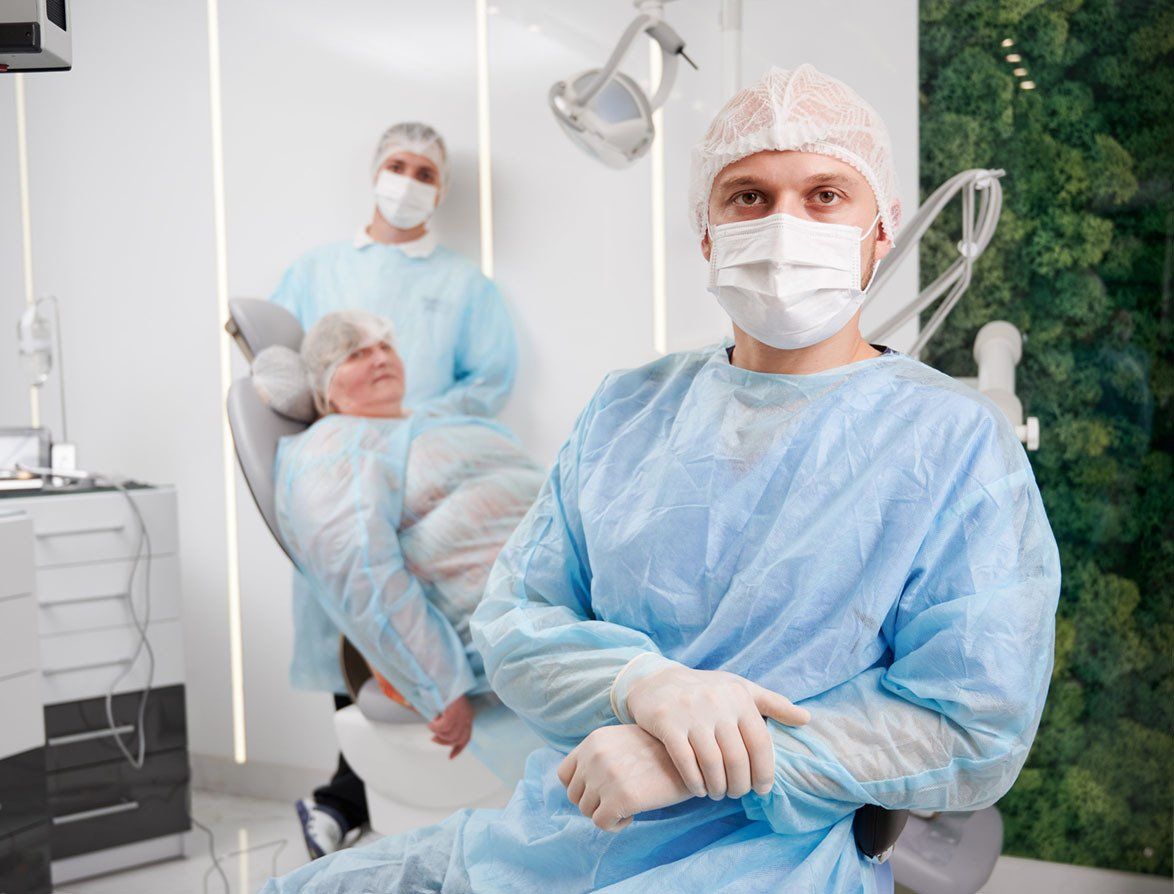 Profile image of a dentist with a patient in the background