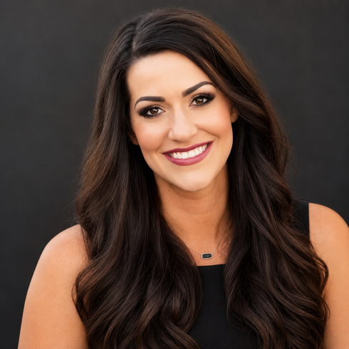 Smiling woman with long dark hair wearing a black top against a gray background